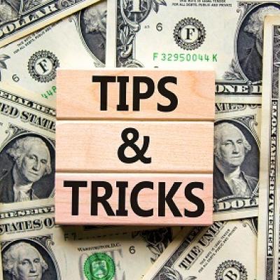 Text reading "Tips & Tricks" over stacks of money